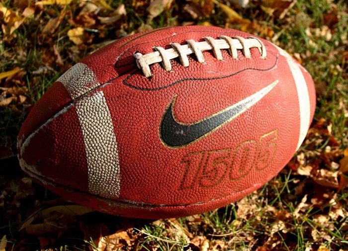 Photograph of a football sitting in the grass