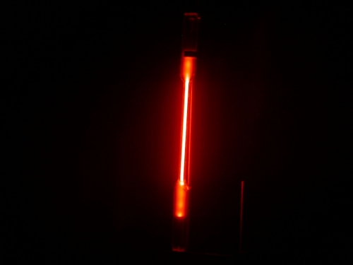 Image of a neon containing bulb glowing red.