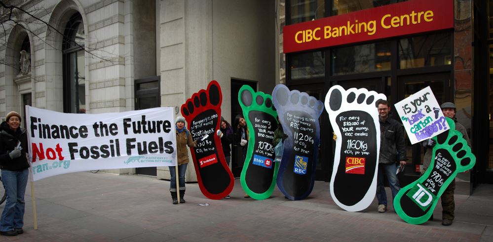 Protesters protesting against fossil fuel investments by banks in Canada.