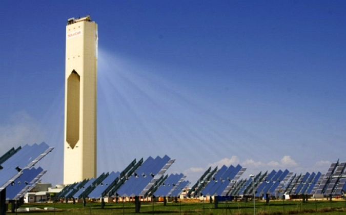 Planta Solar 10 Power Plant in Spain.ridged solar panels with a tall white tower in the middle