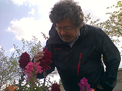 Image of Dr. Semih Eser looking at flowers