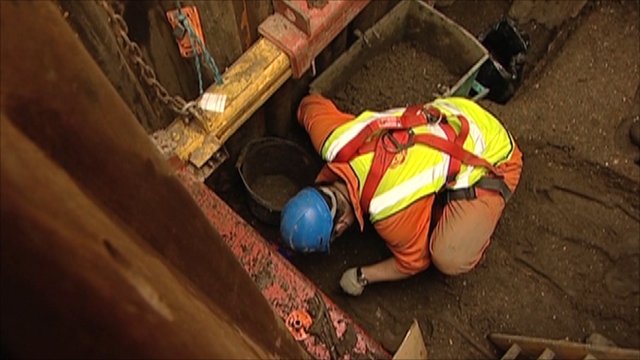 man in the Crossrail Tunnel archaeology dig in London, England.