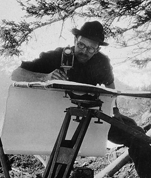 Black and White photo of topographer compiling map using alidade and plane table