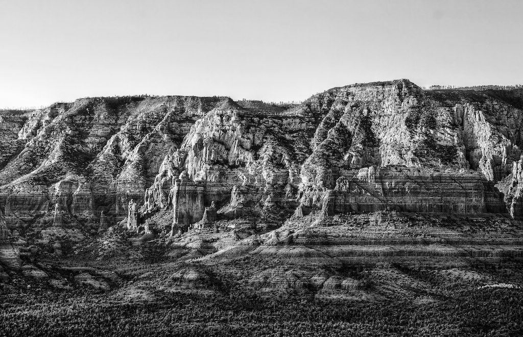 black and white image of a striated cliff side