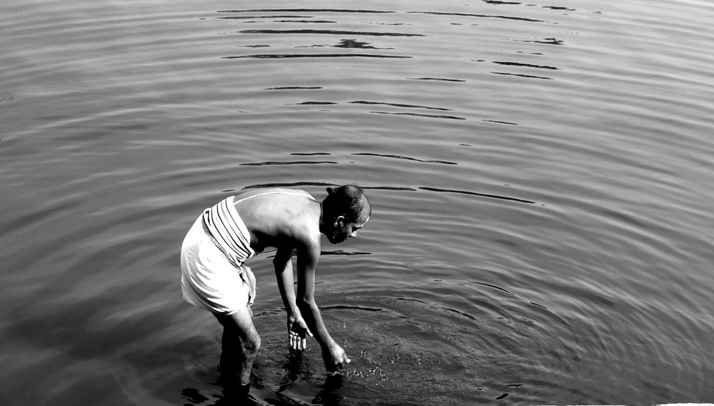 image of man making small ripples in water