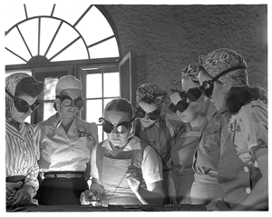 Groups of women wearing goggles in a vocational school
