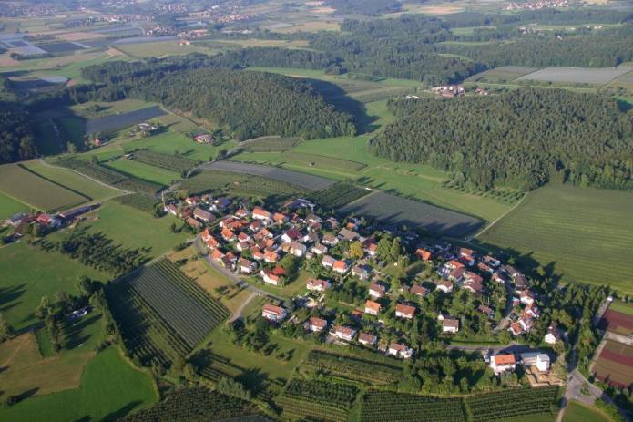 Aerial photograph of a town sitting on a ovular drumlin in southern Germany. 
