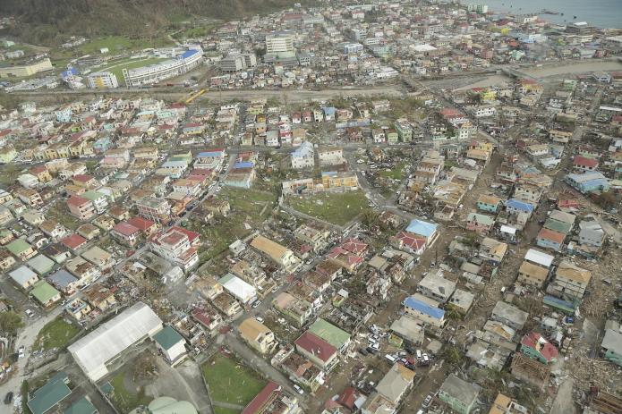 Aerial view of Roseau, showing widespread damage to roofs and congested muddy roadways