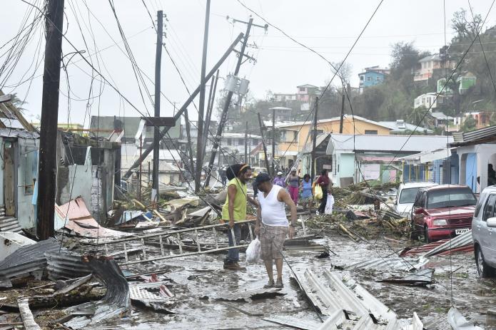 A road in the Roseau area littered with debris and Power lines falling over