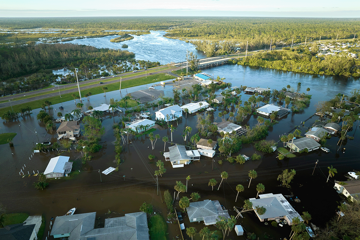 Damage from Maria on Puerto Rico. destroyed houses and trees stripped of their leaves