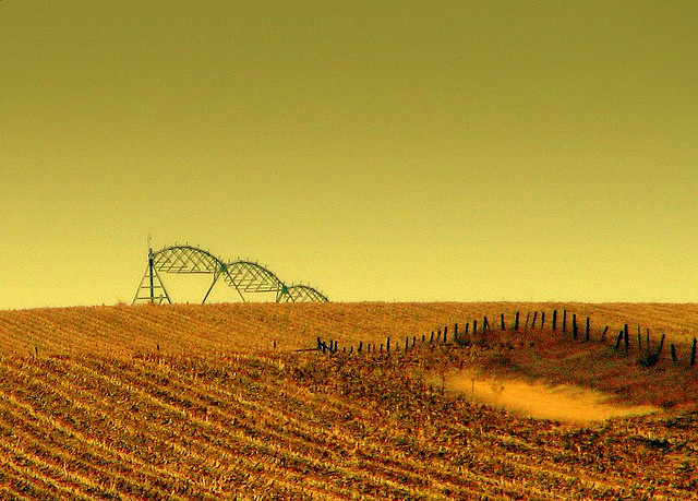 Prarie farm in Nebraska with irrigation sprinklers in the background