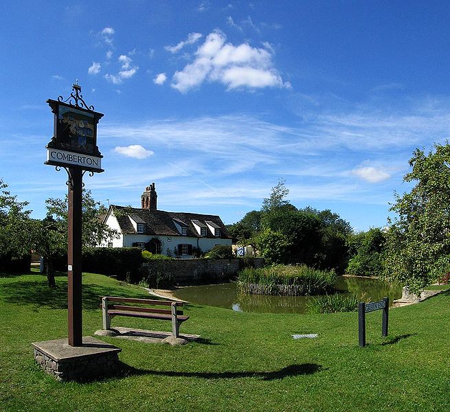 Photograph of the green in Comberton Village, England, which looks like a nice public park with a small pond and well-cared-for grounds.