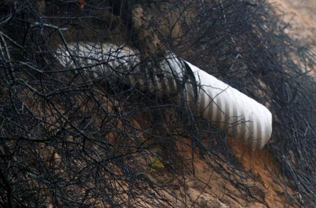 Sewer drainage pipe  pipe was revealed by beach erosion