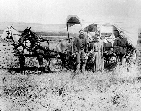 Horse drawn wagon and a homesteading family