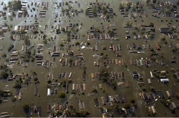 View of flooded neighborhood from the air, only rooftops are visible.