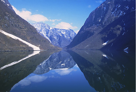 Water between two mountains and a mountain at the end - see caption for more.