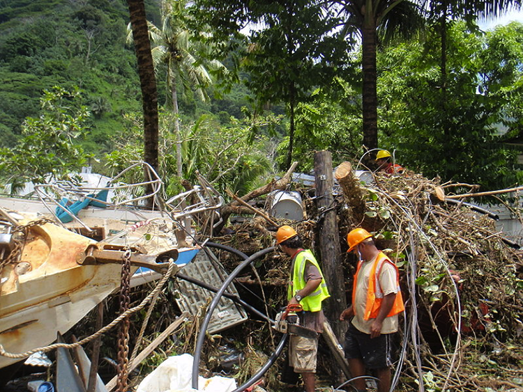 Crews working in tsunami wreckage with chainsaws