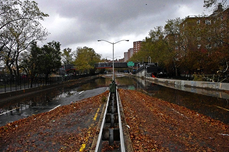 City street covered in water and leaves.