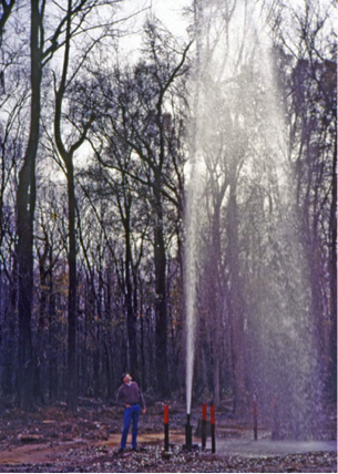 Photo of an artesian well shooting water into the air