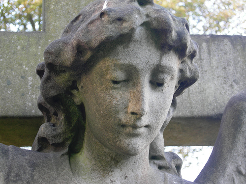 Picture of acid rain stone erosion to statue. Statue's face has discoloration and is splotchy.