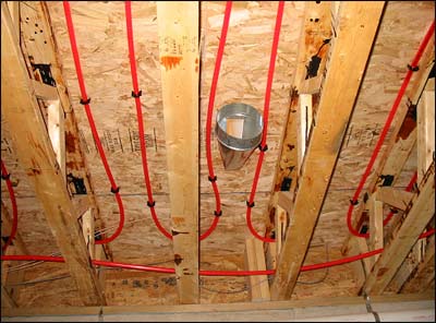 Corrosion-proof, hot-water tubing stapled to the underside of subflooring