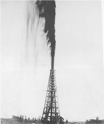 Old photo of derrick with oil gushing into the air