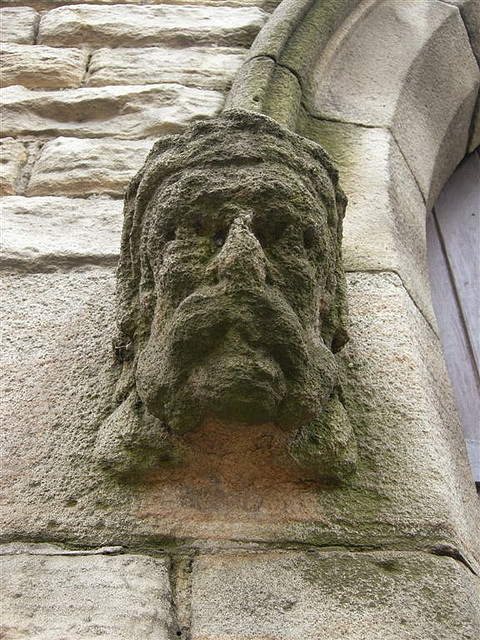 Head sculpture on a doorway. Because of acid rain the features are undistinguishable