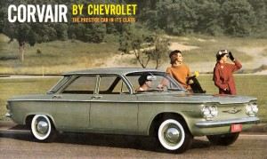 an old chevrolet Corvair sitting on the side of the road.