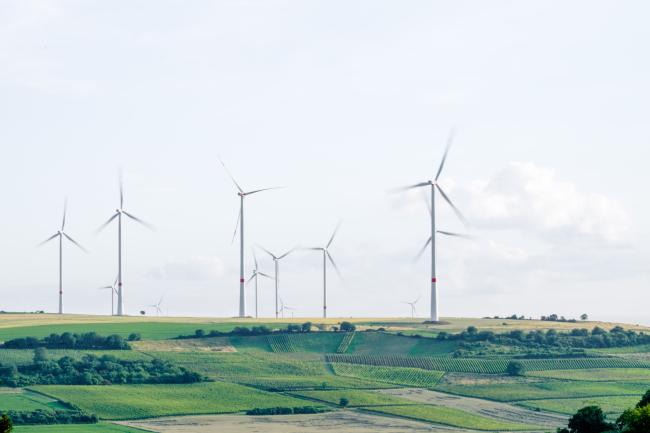 Group of working windmills in a flat landscape
