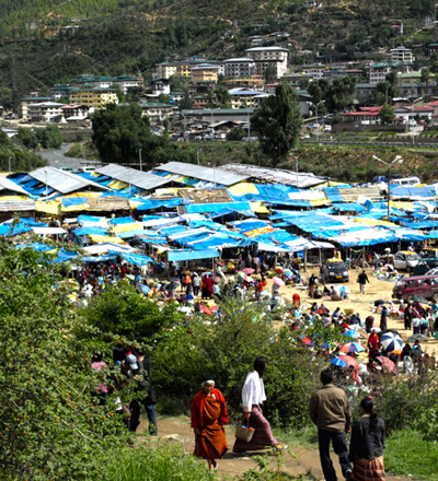  Image of people walking to a market made of tents in Bhutan