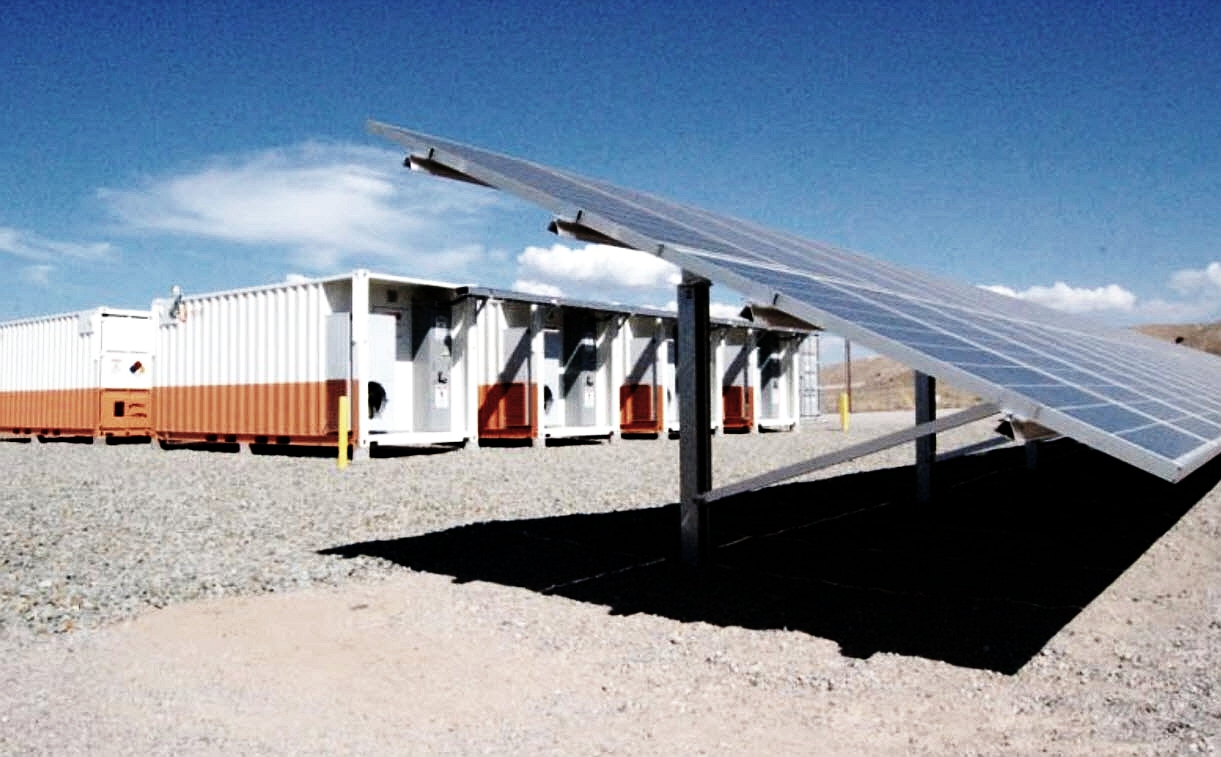 solar panels with corrugated metal buildings behind them