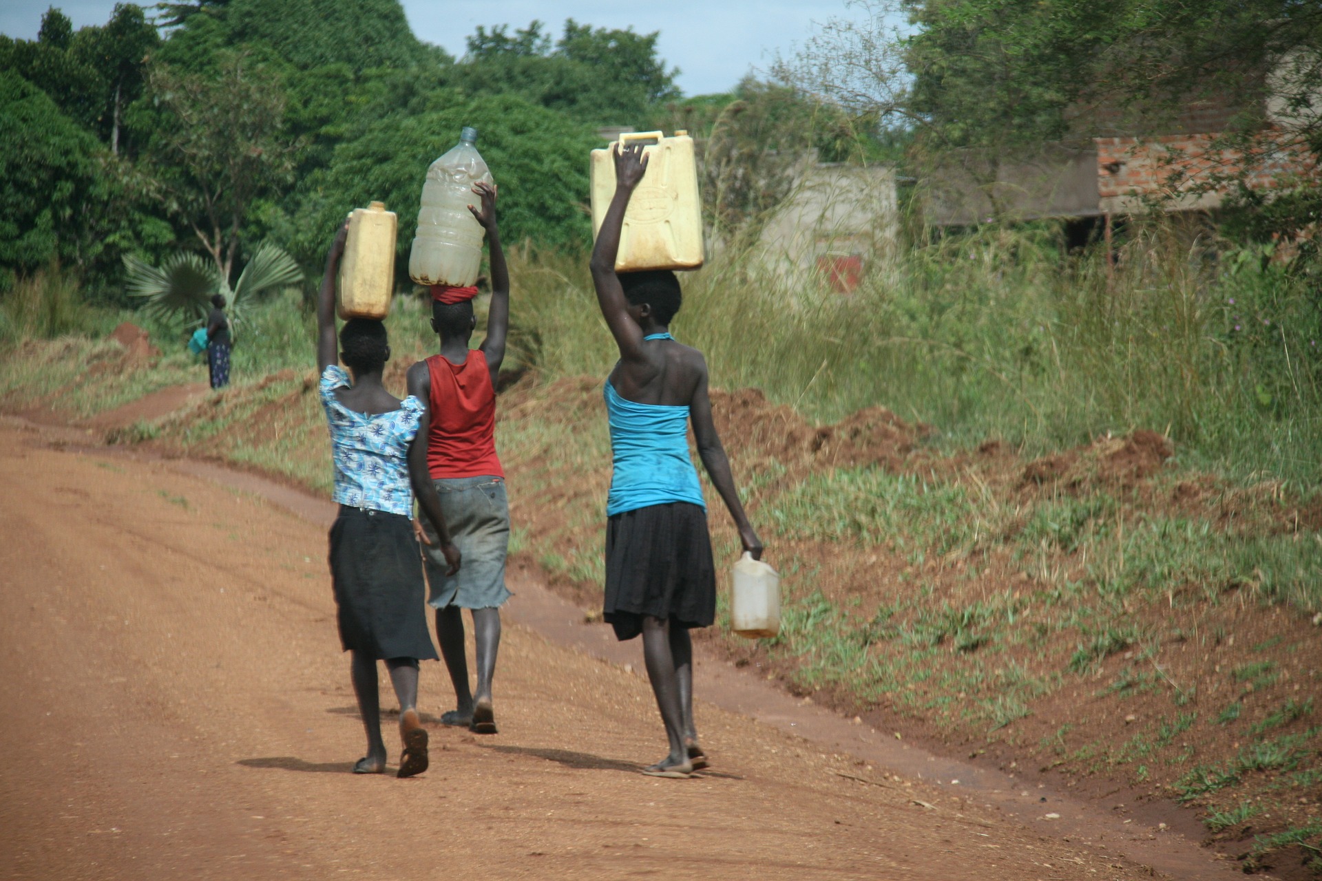 Image of women in Sub-Saharan Africa carrying water on their heads.