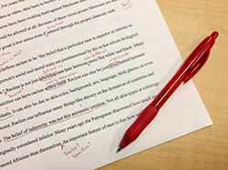 Typed paper with edits made in red ink.