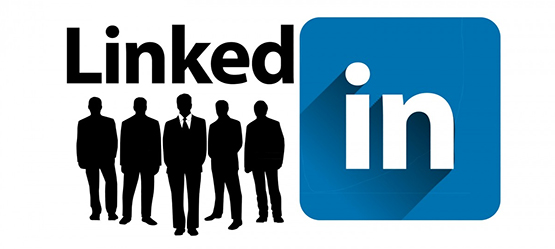LinkedIn logo with silhouettes of business people in the front.