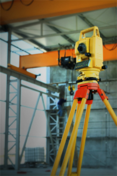 A modern total station. Yellow camera-looking object on a tripod. More in text above.