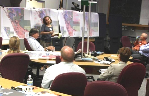 People having a meeting in a map room