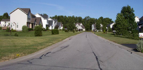 View of a neighborhood with houses and a wide street