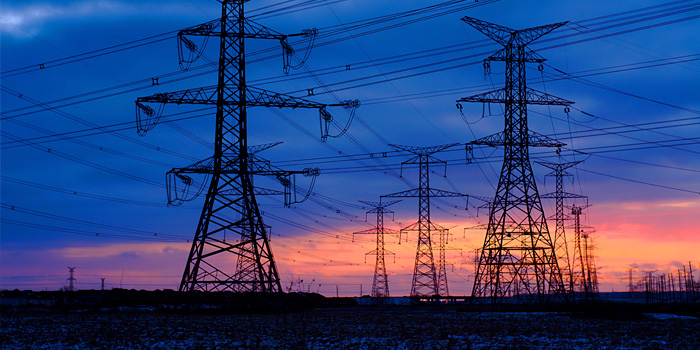 Powerlines crisscrossing against a colorful sunset in Mississauga, Canada