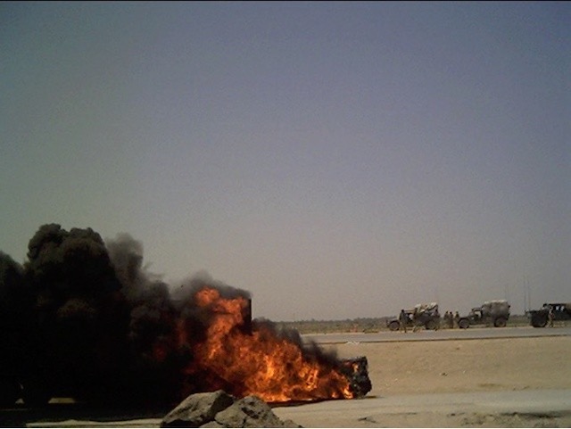 semi-truck carrying supplies burns after enemy strike in Iraq, 2003