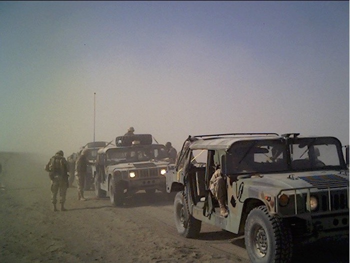 Two Humvee vehicles and military personnel in Iraq