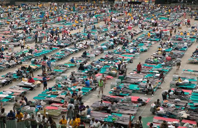 Hundreds of Hurricane Katrina survivors taking refuge in the Houston Astrodome in rows of cots.