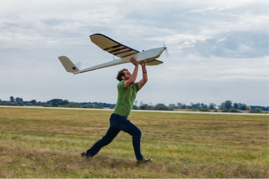 man hand-launching a small UAV