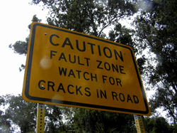 Road sign: “Caution fault zone, watch for cracks in road” on the Big Island of Hawaii 