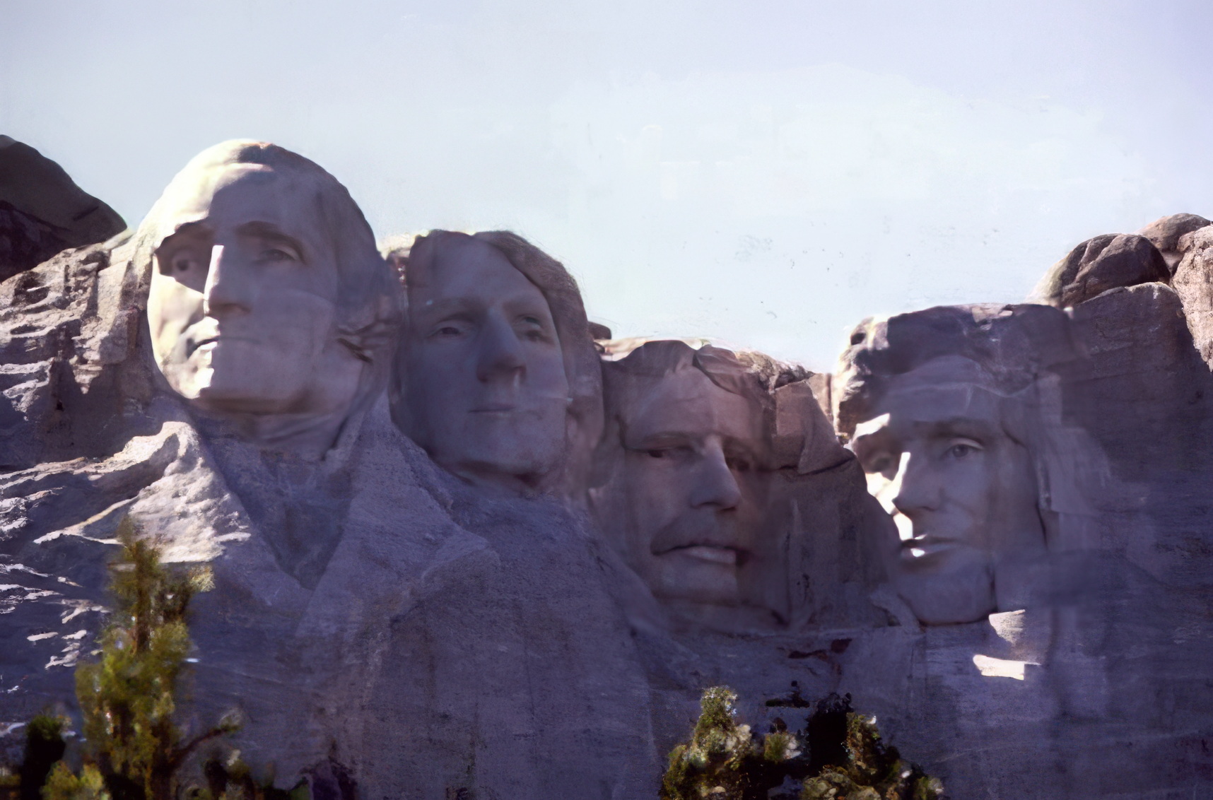 Faces of presidents Washington, Jefferson, T. Roosevelt, and Lincoln carved into a mountainside.