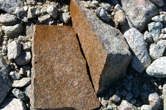 Rock split in two as a result of frost grown in crack. Coast of Greenland