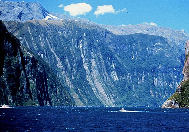 Numerous landslides on the mile-high, glacially carved cliffs in Milford Sound, New Zealand
