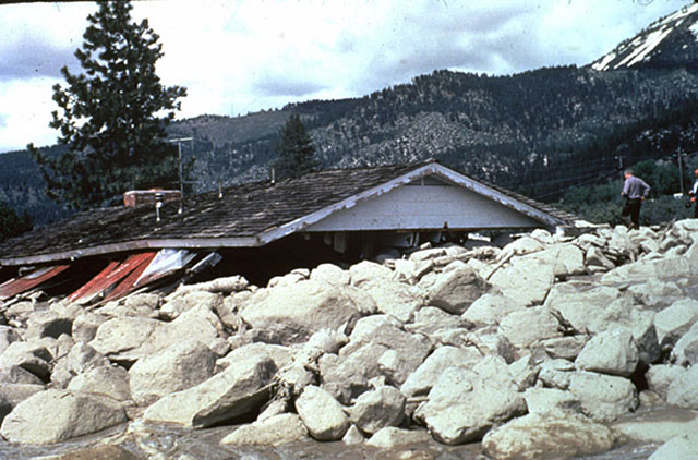 Slide Mountain, Nevada. House buried beneath slide, only roof above surface