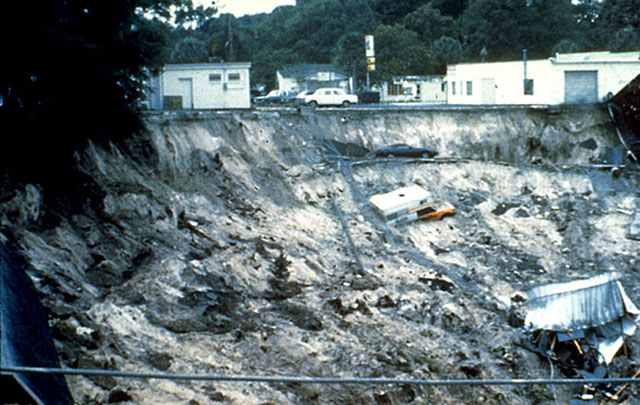 1981 Winter Park, Florida sink hole opening. Car, truck and destroyed building in the sink hole