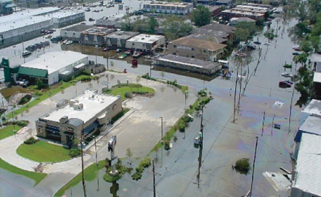 Arial view of Hurricane Katrina flooding in New Orleans. Oil slick can be seen on water surrounding homes and businesses
