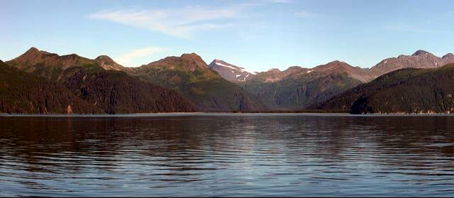 McCarty Glacier, AK, 2004. No glacier visible. Water in foreground, mountains in background.